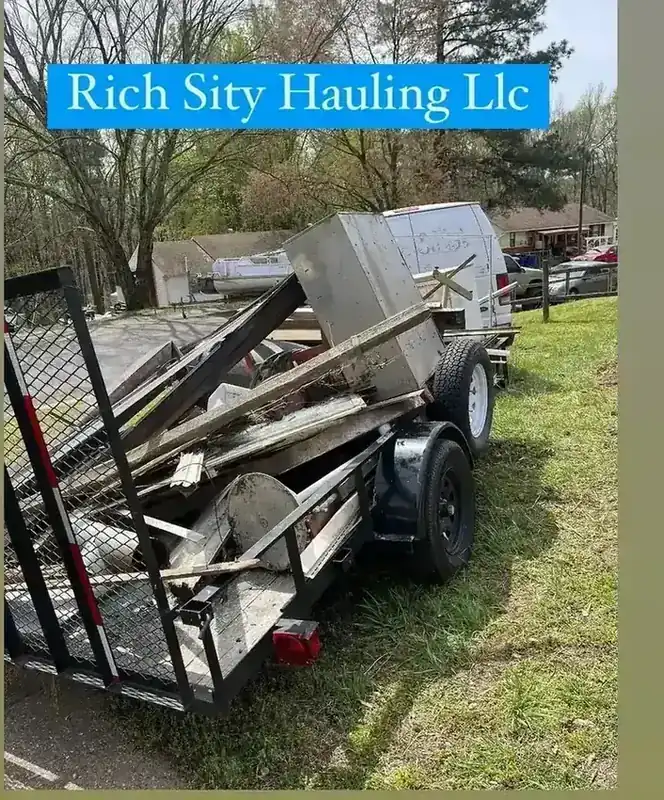 A trailer loaded with scrap metal and timber from a Rich Sity Hauling cleanout