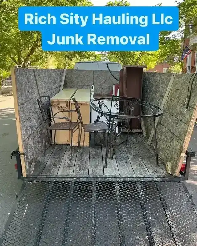 Patio furniture and kitchen cabinets loaded on the Rich Sity Hauling trailer during a Richmond garage cleanout