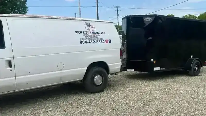 The Rich Sity Hauling van and enclosed trailer, the van door lettered You Call We Haul
